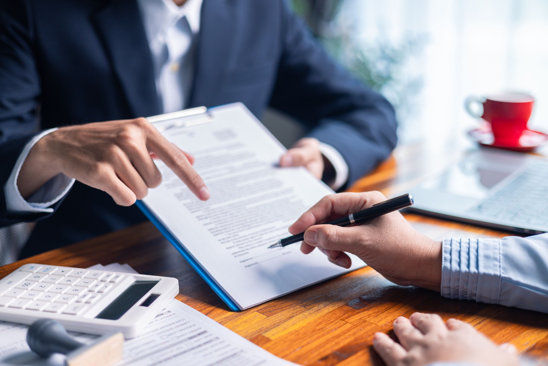 Businesswoman reviewed mortgage document and contract with their client, ensuring loan and credit details were clear, while discussing estate insurance and other finance aspects. finance, credit, pay.